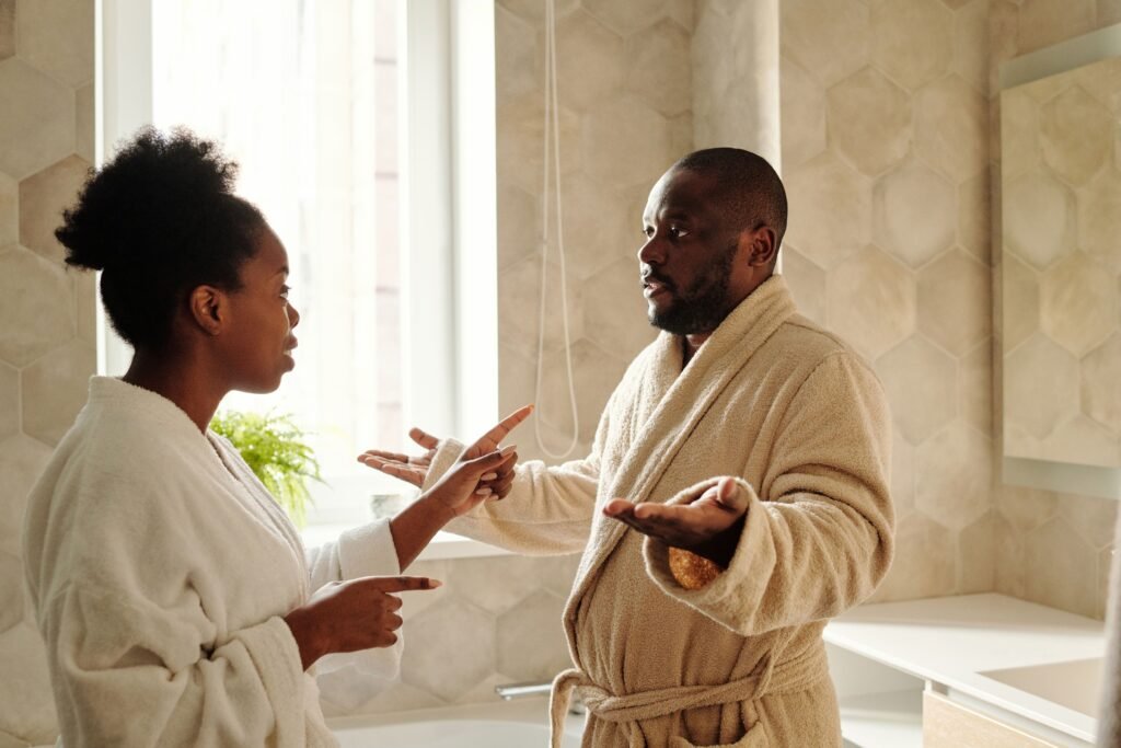 pexels-diva-plavalaguna-5710385 Black couple arguing in bathroom wearing bath robes