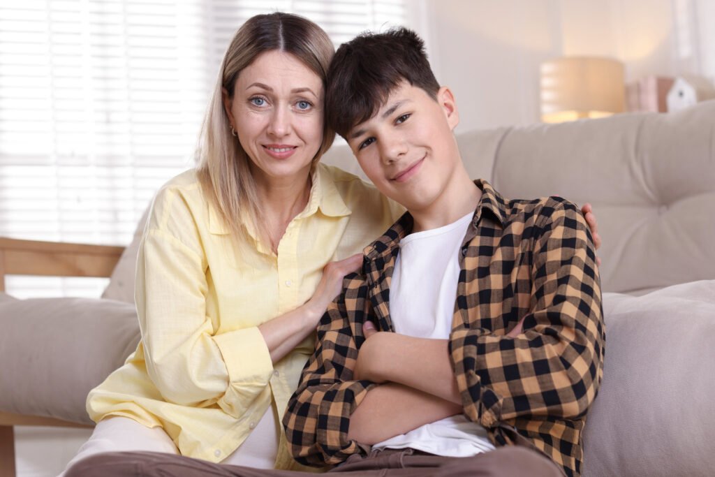 Mother and her son near sofa at home Black couple arguing in bathroom wearing bath robes